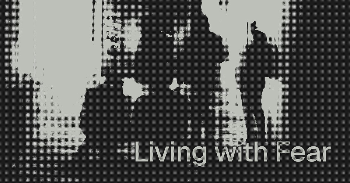 A monochrome halftone street scene with the words "Living with Fear".